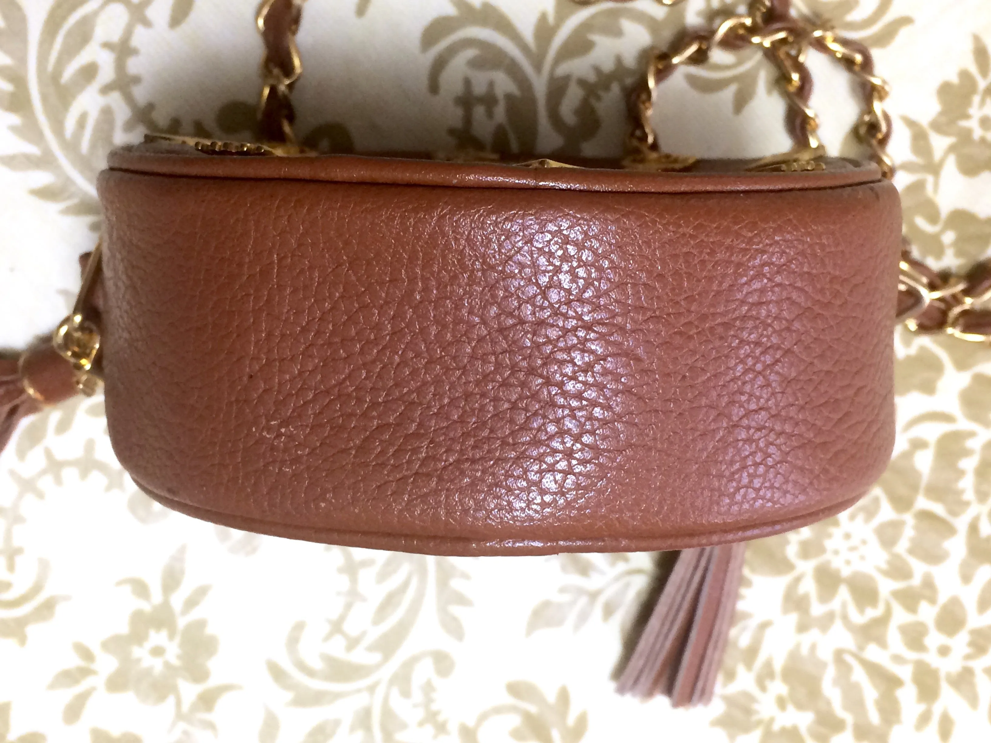 Vintage MCM brown leather round mini Suzy Wong shoulder bag with golden logo motifs. trimmings. Designed by Michael Cromer.