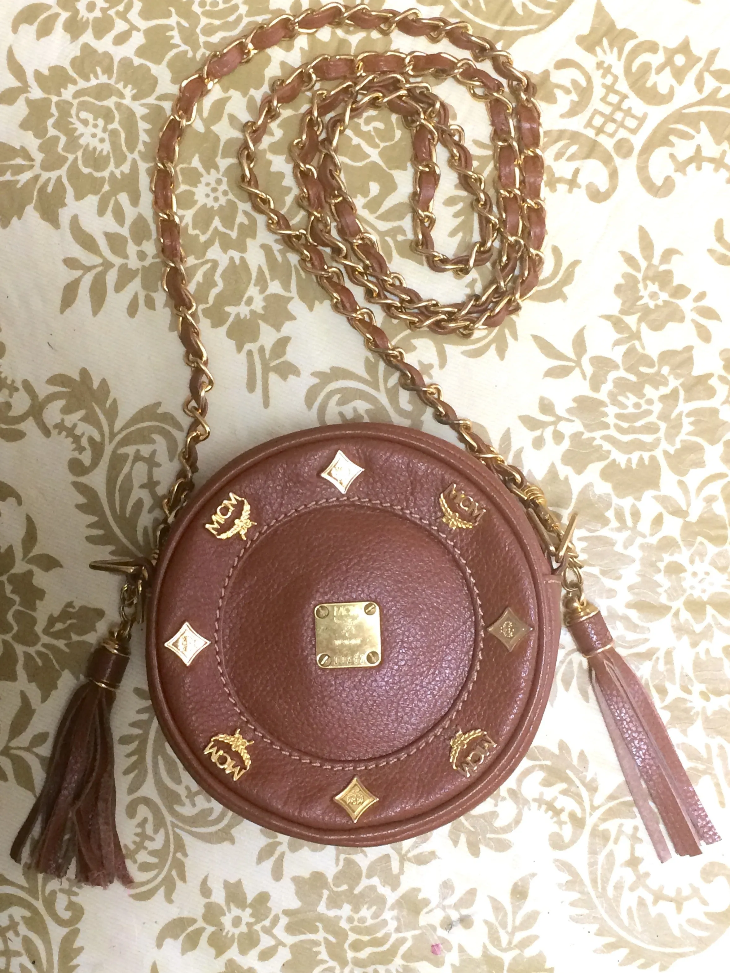 Vintage MCM brown leather round mini Suzy Wong shoulder bag with golden logo motifs. trimmings. Designed by Michael Cromer.