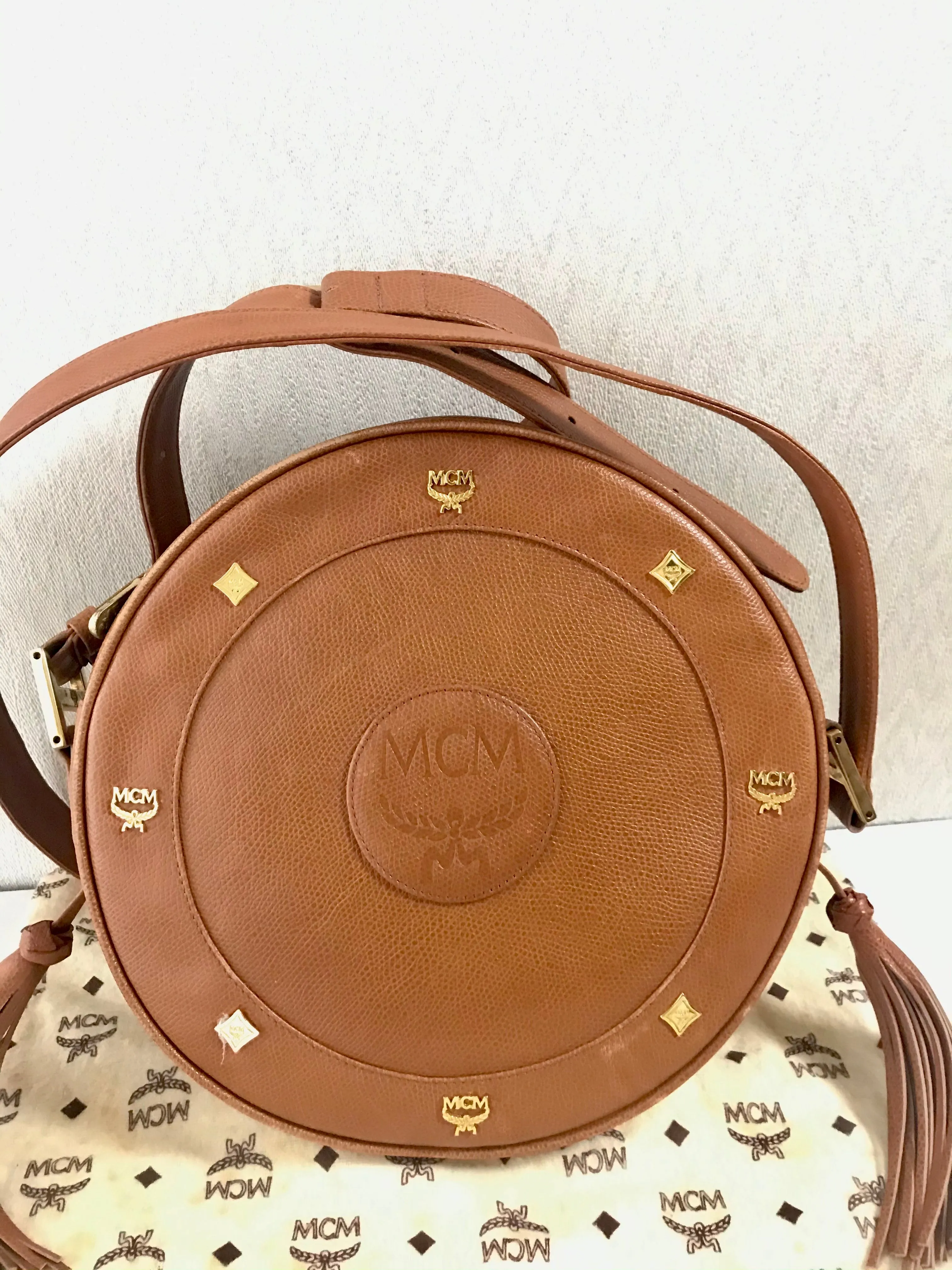 Vintage MCM suzy wong bag, brown grained leather round shoulder bag with studs and fringes. Designed by Michael Cromer. Nature. 060531r8