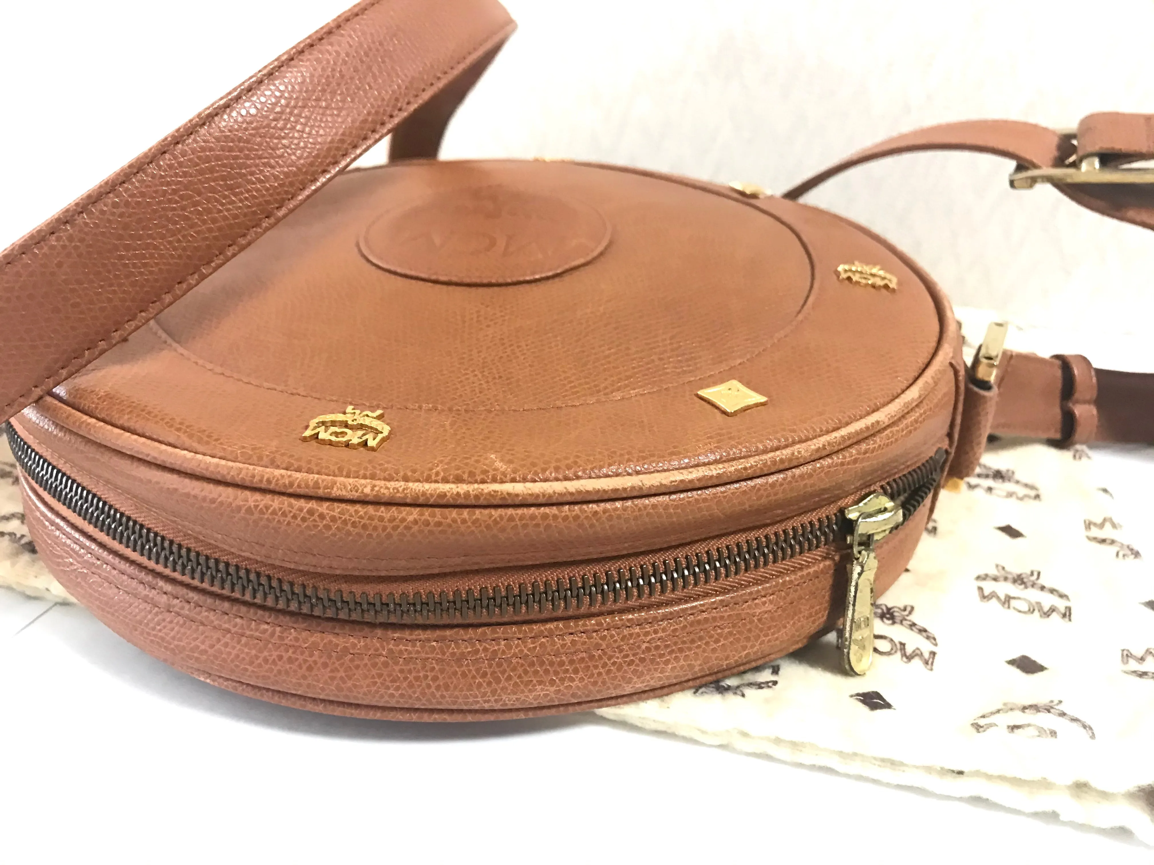 Vintage MCM suzy wong bag, brown grained leather round shoulder bag with studs and fringes. Designed by Michael Cromer. Nature. 060531r8
